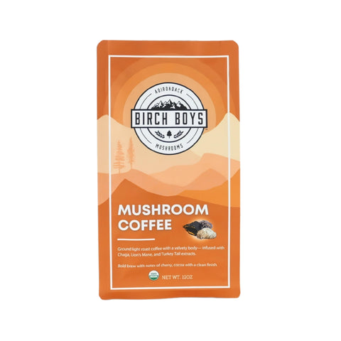 Front side of a bag of Birch Boys Mushroom Coffee. Product description says "Ground light roast coffee with a velvety body--infused with Chaga, Lion's Mane, and Turkey Tail extracts. Bold brew with notes of cherry, cocoa with a clean finish."