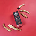 Reishi mushroom tincture on red background with reishi slices