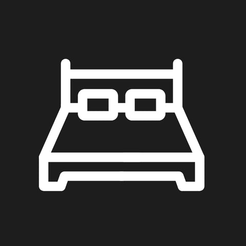 A white icon of a bed on a dark gray background