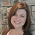 Gift wrap portrait of a smiling woman with shoulder-length brown hair.