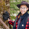 Garrett Kopp, expert chaga harvester with chaga tree, basket and axe