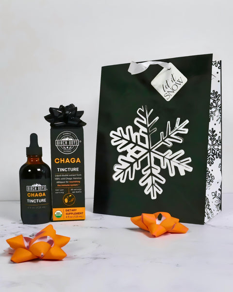 Tincture bottles and a decorative bag with snowflake design on a white background