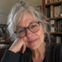 Gift wrap portrait of a woman with gray hair and glasses, smiling.