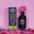 Bottle and packaging of Birch Boys Maitake Tincture on a pink background.