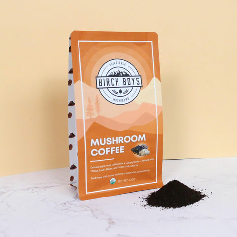 Bag of Birch Boys Mushroom Coffee with a pile of ground coffee in front