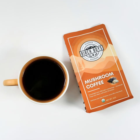 A mug of coffee next to a bag of Birch Boys Mushroom Coffee