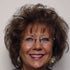 Woman with glasses and a neutral background